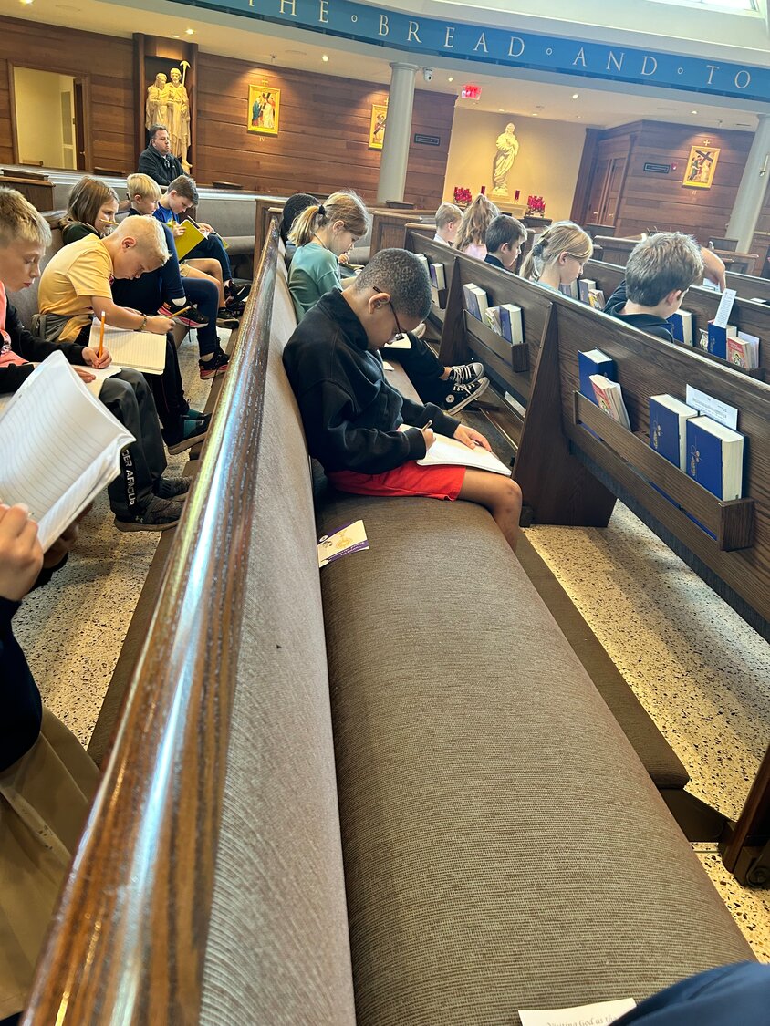 Second-graders at St. Joseph Cathedral School in Jefferson City pray for peace and record their thoughts in a prayer journal during the Oct. 17 day of prayer and fasting for peace in the Holy Land.